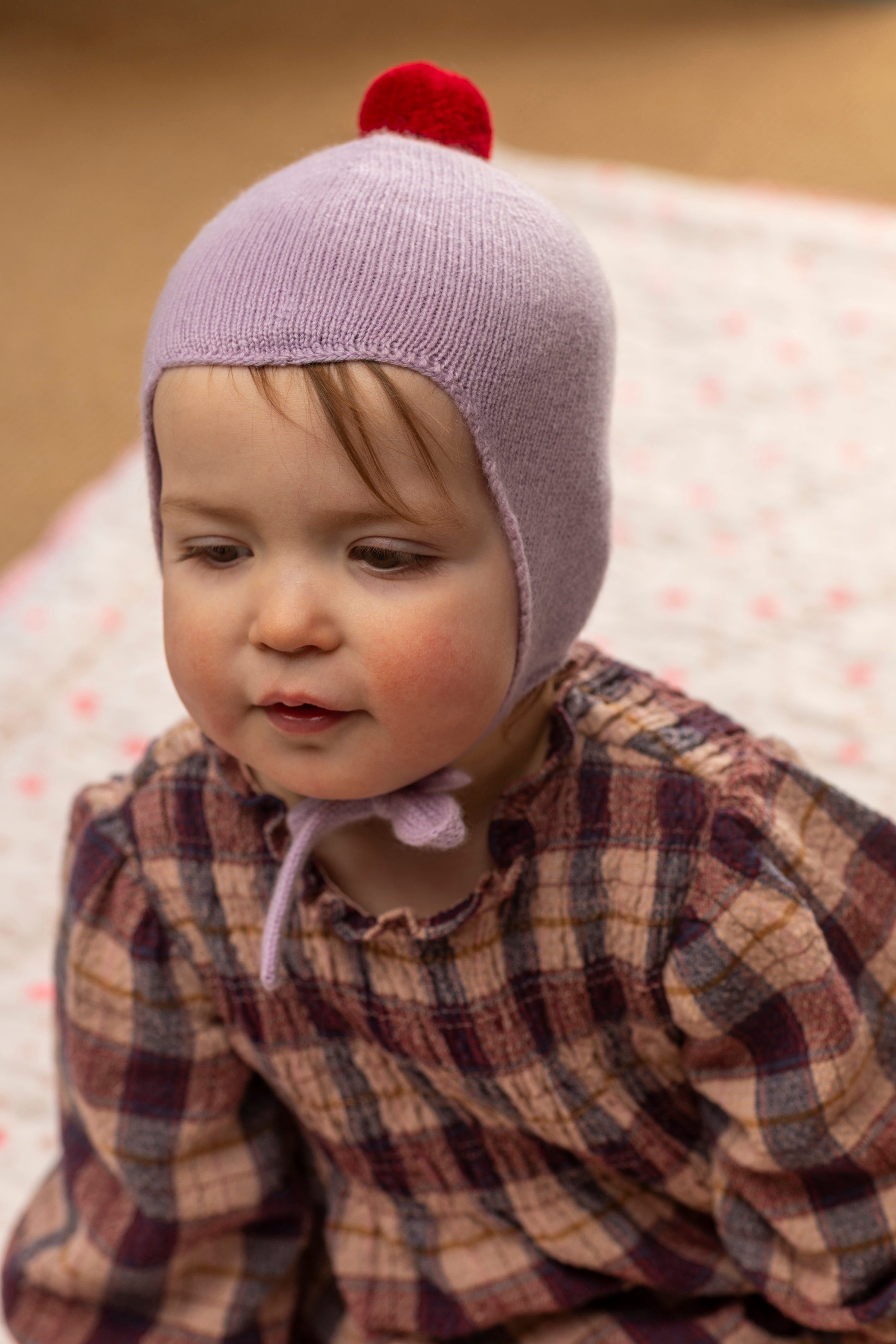 Rosie Sugden Cashmere's Baby Bonnet in Lupin with Chianti Pom-Pom