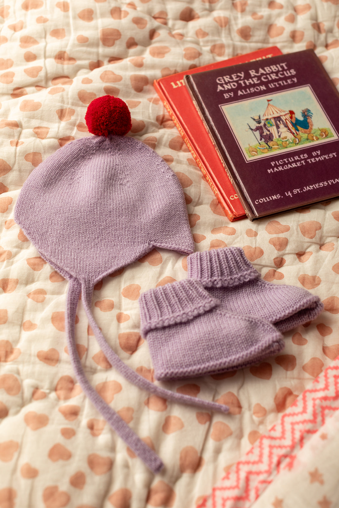 Rosie Sugden Cashmere's Baby Bonnet in Lupin with Chianti Pom-Pom